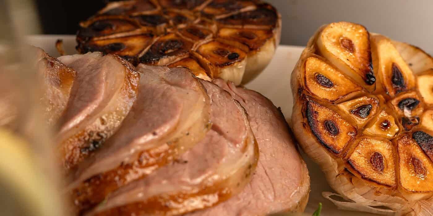 Savour succulent roasted meats and grilled garlic at Palm House Boutique Hotel and Spa, renowned for luxurious accommodations and gourmet dining experiences in South Africa.