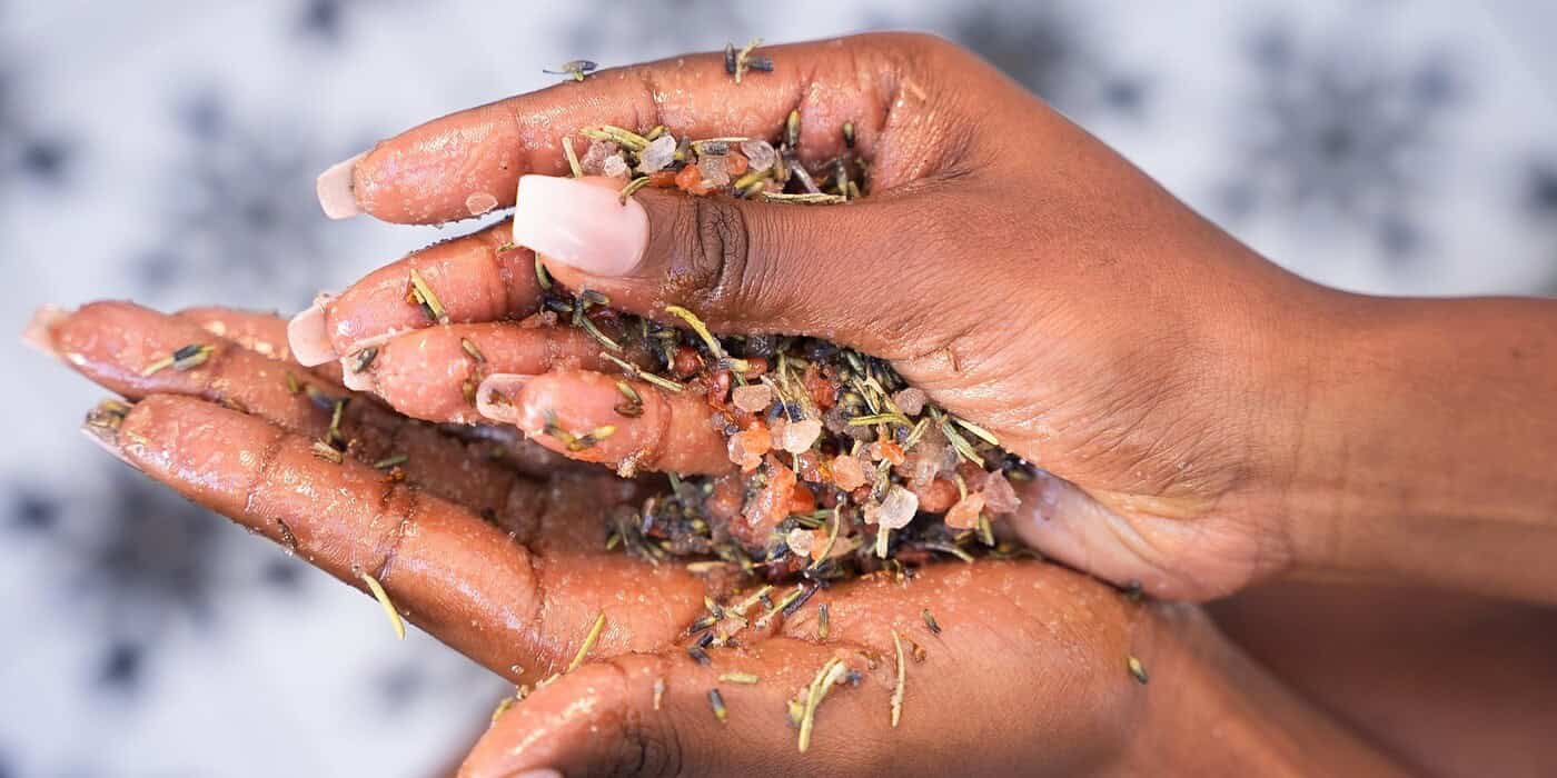 Freshly harvested herbal bath salts with natural salts, dried herbs, and flower petals for relaxation and wellness.