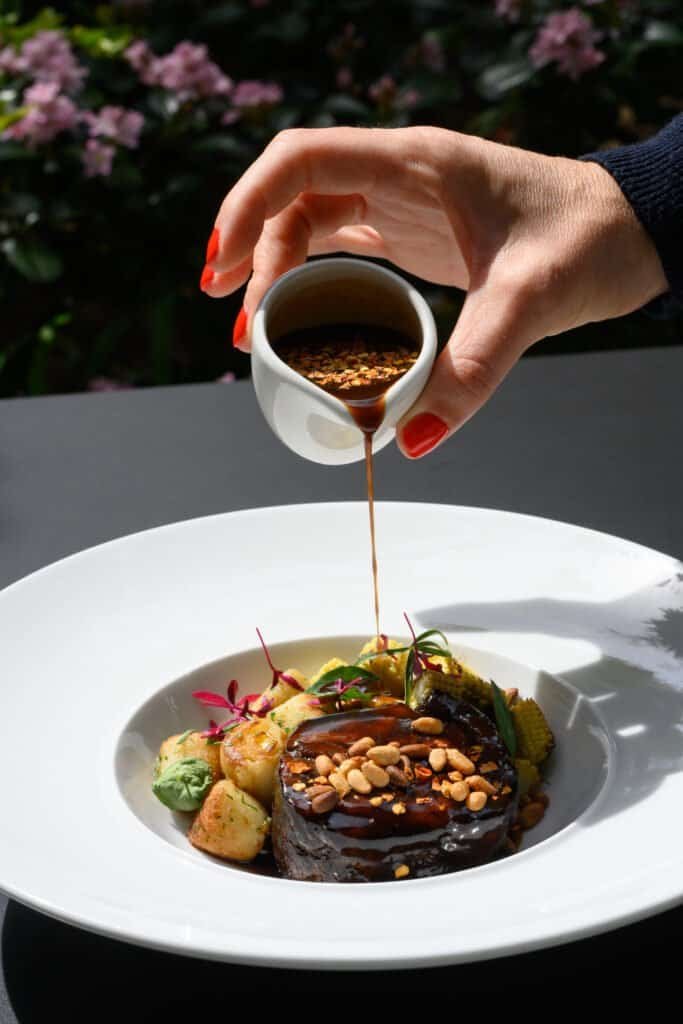 Luxury hotel with exquisite restaurant, serving gourmet desserts and premium coffee in a serene atmosphere, ideal for guests seeking relaxation and elegance.